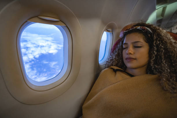 istock Woman traveling by plane and sleeping 1126924507