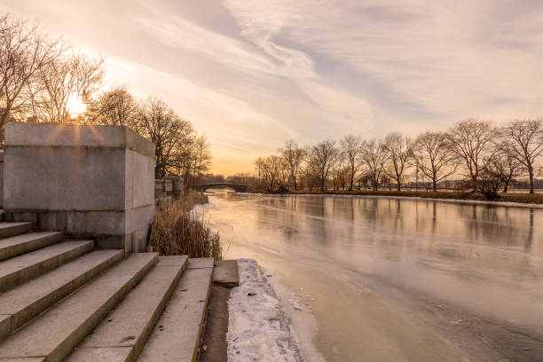 Steps leading down to frozenCharles River, Boston, Massachusetts at Sunset