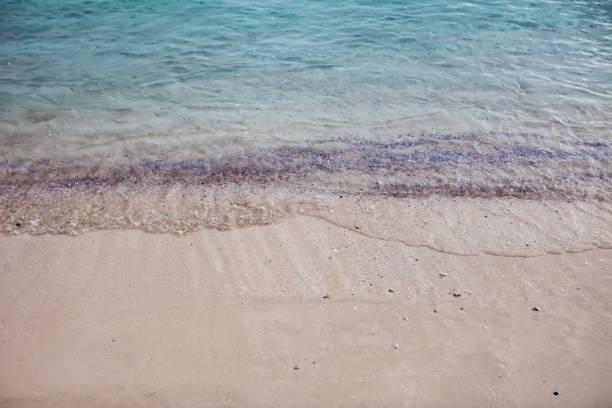 istock Soft wave of blue ocean on sandy beach. Background. 1126925965