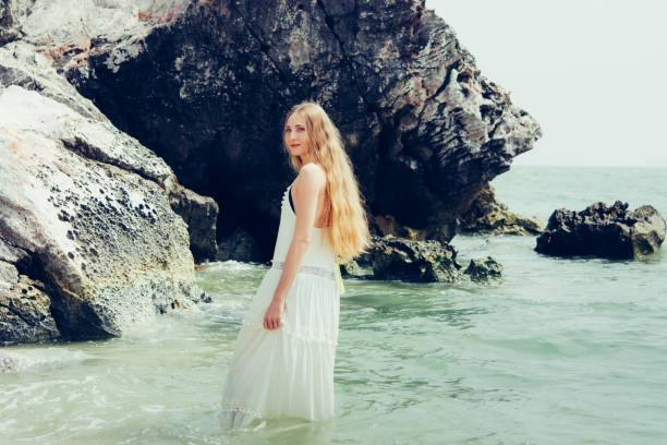 istock Young blond woman on vacation on the beach. 1126926682