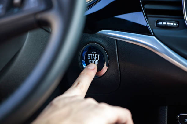 Engine start and stop button. Man hand pressing car start and stop button. start button stock pictures, royalty-free photos & images