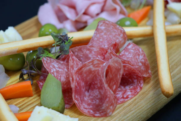 istock cold cuts in wood board with all the condiments 1126931135