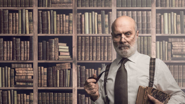 istock Professor posing in the library with books 1126933577