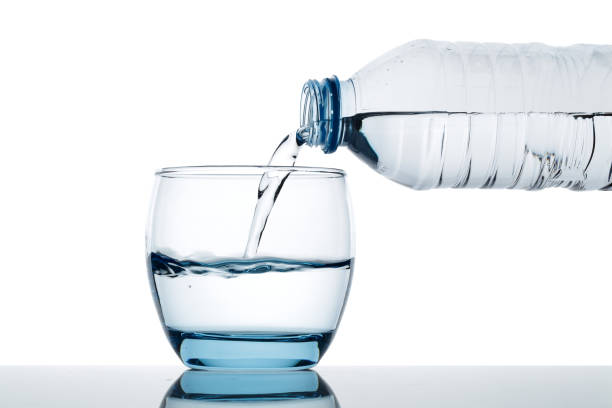 istock Drinking water is poured into a glass from the bottle 1126933783