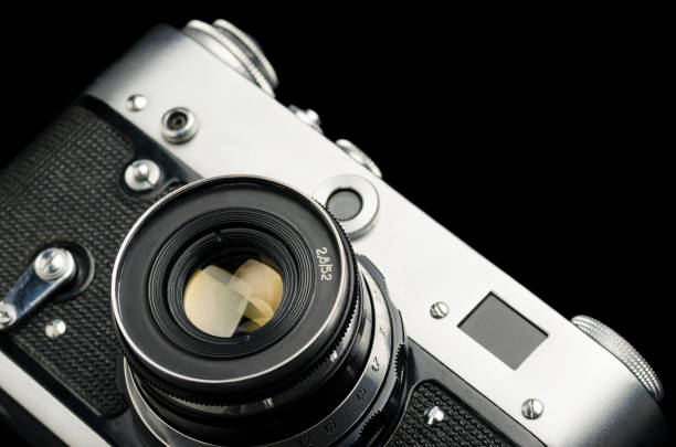 istock Old vintage film camera on black background 1126937879