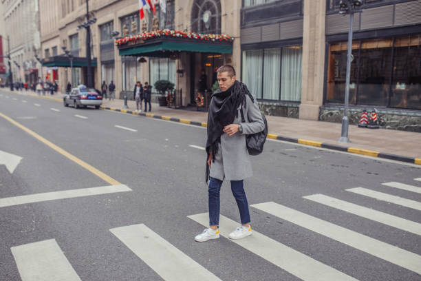 istock Stylish man crossing the street 1126938735