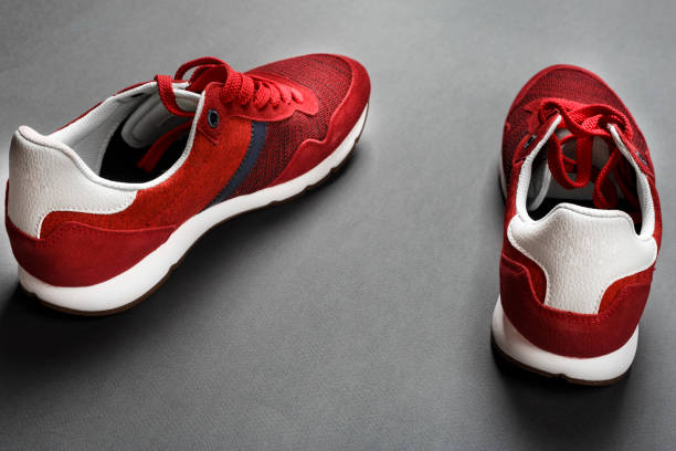 istock A pair of red mens sneakers on a black background. 1126939191