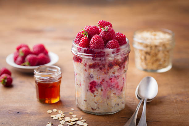 istock Overnight oats, bircher muesli with raspberry in a glass jar on wooden table background. 1126939604