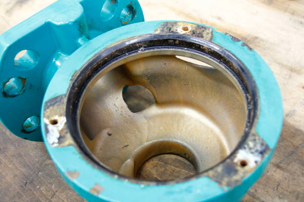 Hole in a housing of a water pump. The hole was created by abrasion with sand. Hole in a housing of a water pump. The hole was created by abrasion with sand. abwasser stock pictures, royalty-free photos & images