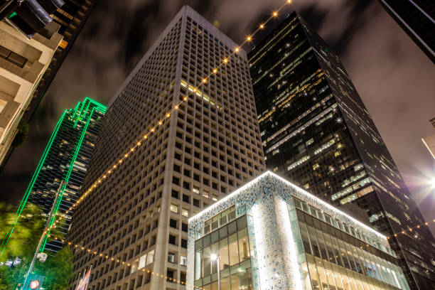 istock Looking up at Skyscapers Lit at Night in Dallas 1126939779