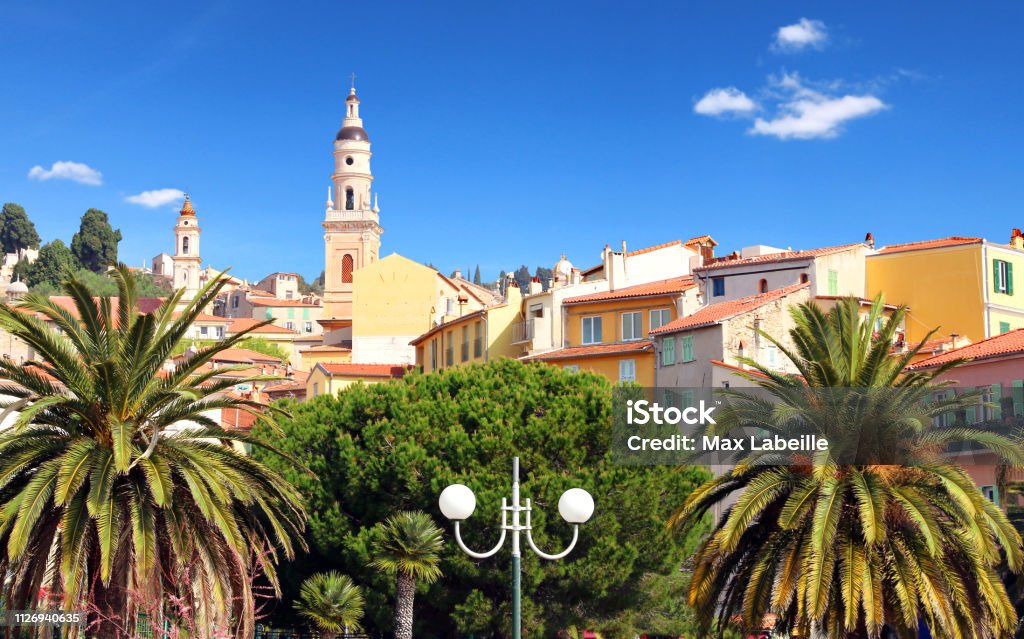 Menton on the French Riviera. France. The palms and the ocher color of the town's houses, known for its beaches and gardens, reflect the purely Mediterranean style. Alpes-Maritimes Stock Photo