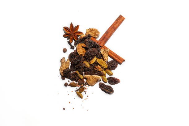 istock Fragrant spices for making hot winter drink - mulled wine: cinnamon sticks, anise stars, spicy ingredients from dried organic seasoning in a handful on a white background. 1126942193