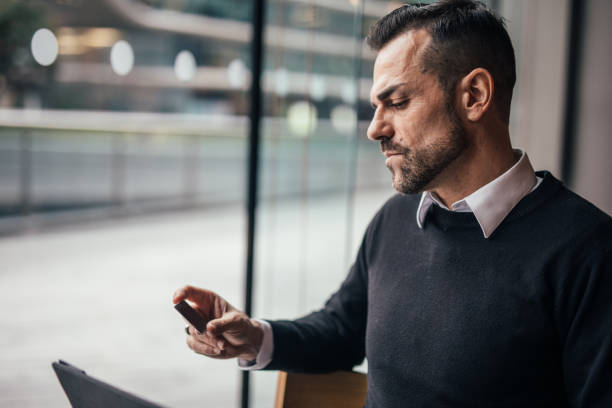 istock Man sitting in the caffee shop and paying online 1126943904