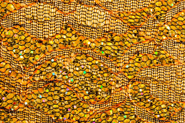istock Abstract textured background of gold sequins and lace 1126944100