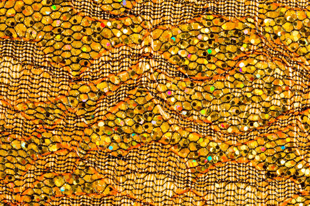 istock Abstract textured background of gold sequins and lace 1126944466