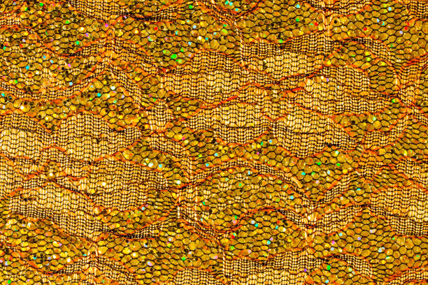 istock Abstract textured background of gold sequins and lace 1126944685