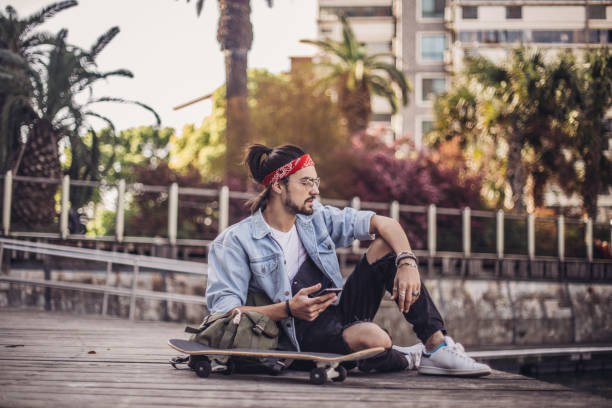 istock Skater man texting outdoors 1126944933