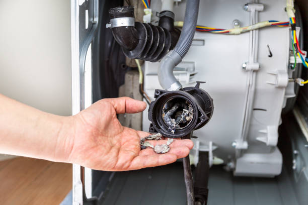 istock Plumber repairing washing machine, washing machine pump clogged 1126945781