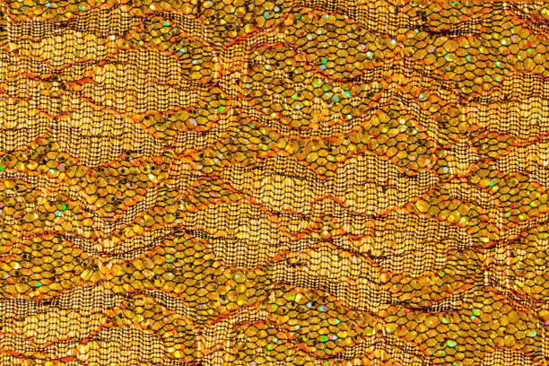 istock Abstract textured background of gold sequins and lace 1126945868