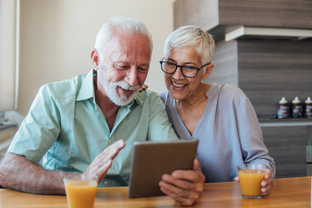 istock Couple looking at digital tablet and smiling 1126948538