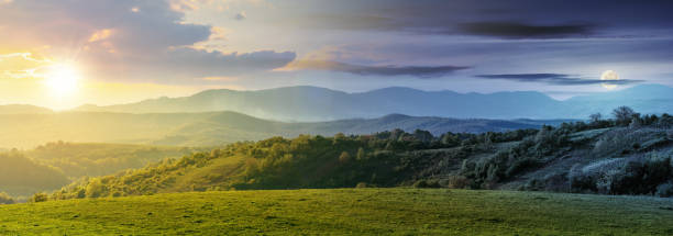 time change above panorama of romania countryside day and night time change above panorama of romania countryside. wonderful springtime landscape in mountains with sun and moon. grassy field and rolling hills. rural scenery alpine climate photos stock pictures, royalty-free photos & images