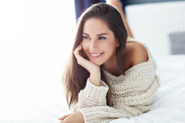 istock Young beautiful woman waking up in her bed fully rested 1126948883