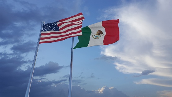 Portrait of a traditional mariachi holding Mexican flag outdoors