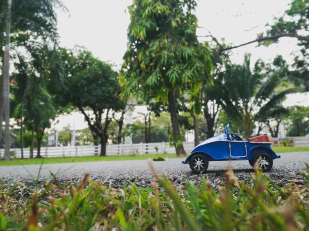 istock The blue classic car on the road 1126951043