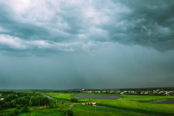istock Rain clouds over the field with a lake 1126951373
