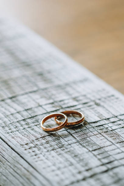 istock Beautiful wedding rings on a wooden surface 1126951389