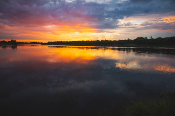 istock Orange sunset on a river in the clouds 1126951412