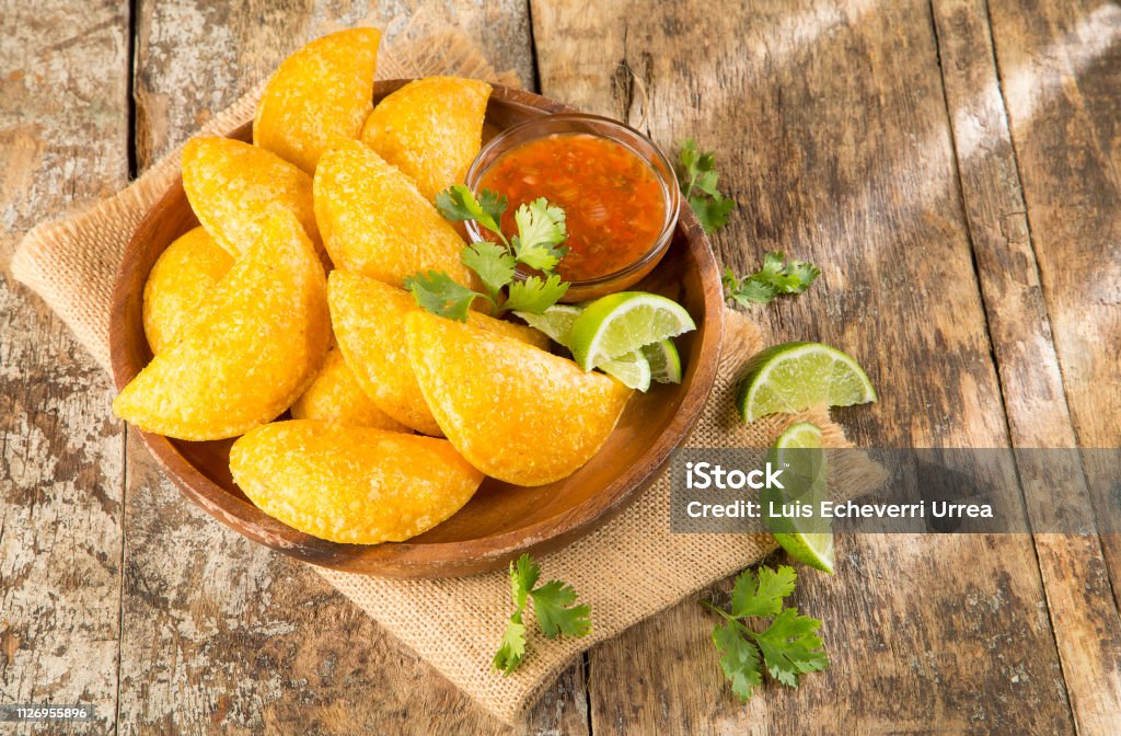 Colombian empanada with spicy sauce Empanada Stock Photo