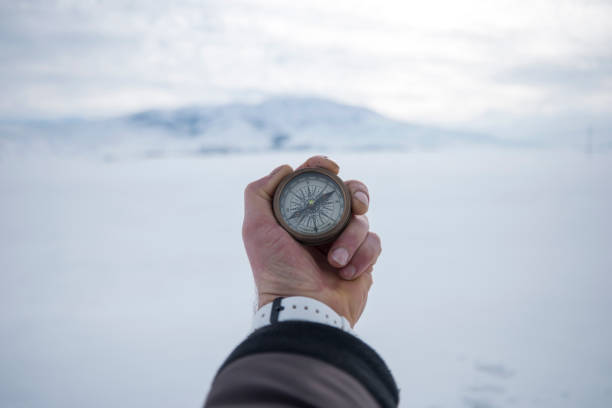 istock Man holding a metal compass on mountain 1126956126