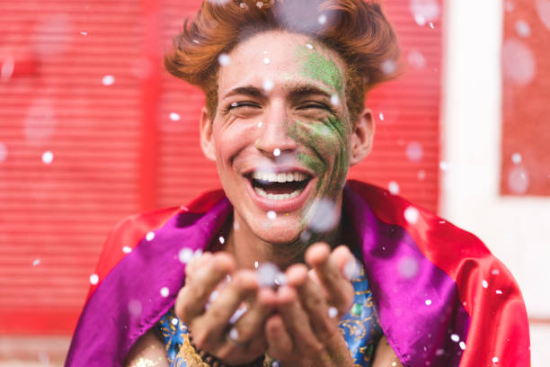 istock Homem blow confetti from hands 1126957480