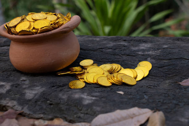 istock Stacking Gold Coin in jar on wooden with blurred background, Money stack for business planning investment and saving future concept 1126957816