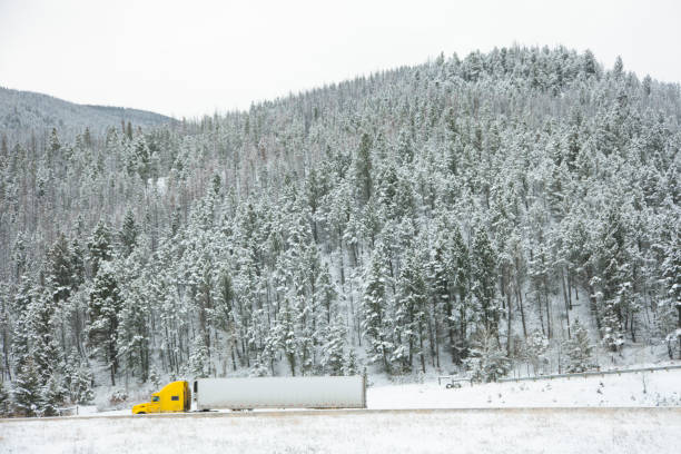 istock Semi Truck on a Snowy Mountain Highway 1126959654
