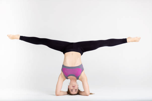 istock Young sportwoman stretching muscles on white background 1126960722