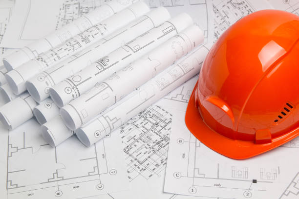 istock Paper architectural drawings, blueprint  and helmet. Engineering blueprint 1126961117