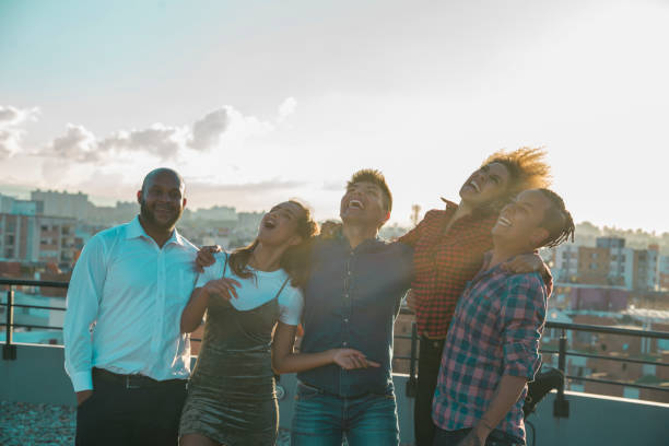 istock Friends enjoying the sunset in the rooftop 1126962078