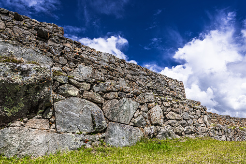 Clouds and blue sky over the remains of the ancient Inca wall in Cusco.