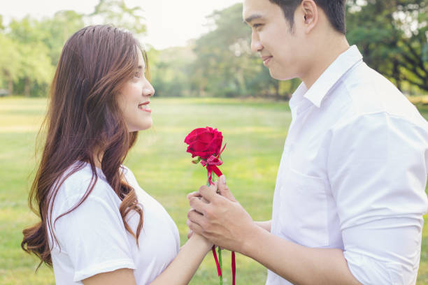 istock Man giving rose to girlfriend 1126963599
