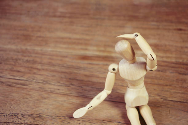 istock Wooden model doing dramatical pose on wooden table 1126965009