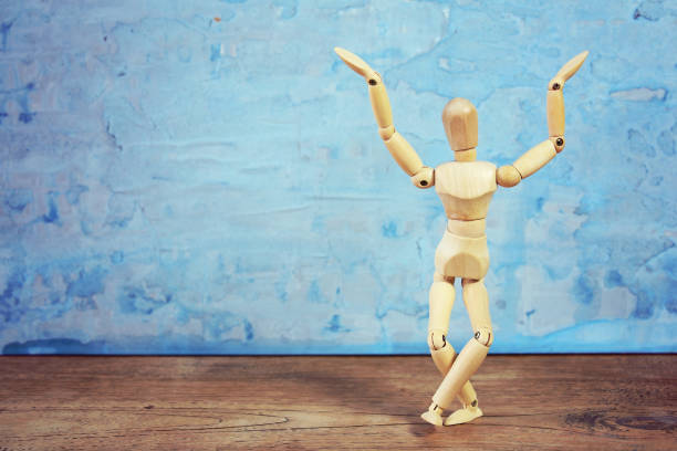 istock Expression of a wooden model doing dramatical pose on blue background 1126965038