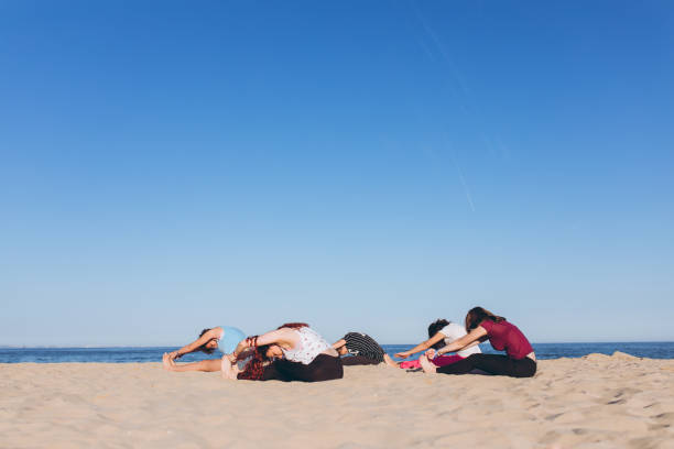 istock Group yoga on the beach 1126965050