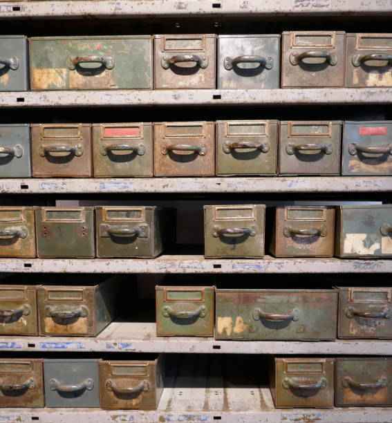 istock Old rosty shelf with many drawers and boxes in a disused workshop 1126965273