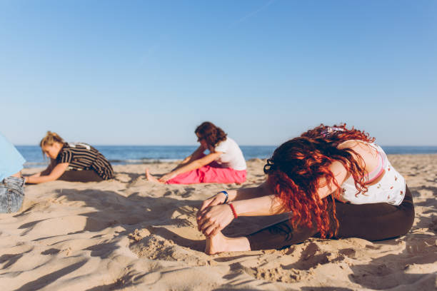 istock Group yoga on the beach 1126965356