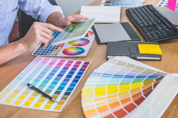 istock Image of male creative graphic designer working on color selection and drawing on graphics tablet at workplace with work tools and accessories in workspace 1126967203