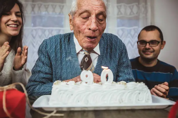 Senior man is celebrating birthday with his family