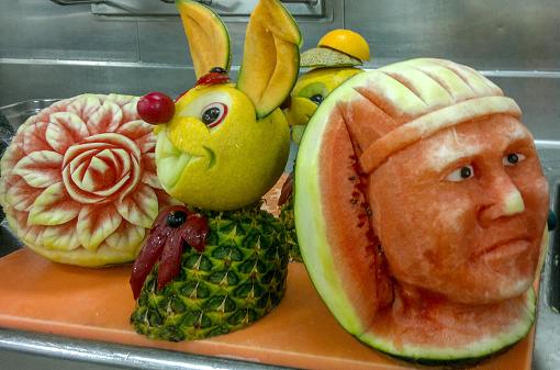 View of the funny sculpture carved from a fruits.