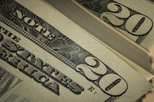 macro closeup of US American dollar bills stacked new currency